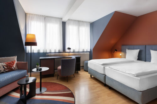 Hotel La Pergola's comfort room with two beds designed for relaxation and convenience.